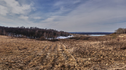 Panorama of the landscape of central Russia.Spring landscape of Russian nature. Fields, forests, hills, plain, open view and horizon, the sky connects to the earth. Russia, the village of Big Boldino