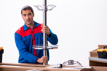 Young handsome male carpenter working indoors