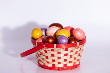 Easter eggs in basket isolated on white