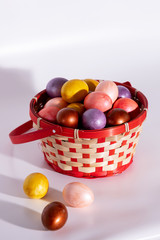 Easter eggs in basket isolated on white