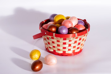 Easter eggs in basket isolated on white
