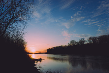 Sunset on a big spring river.