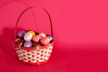 Easter eggs in basket isolated on red