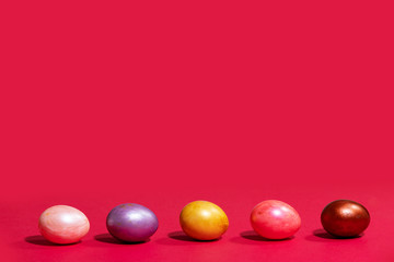 Easter painted eggs isolated on red background
