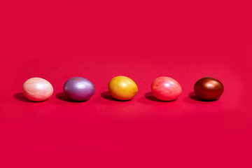 Easter painted eggs isolated on red background