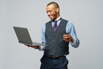 professional african-american business man holding laptop computer