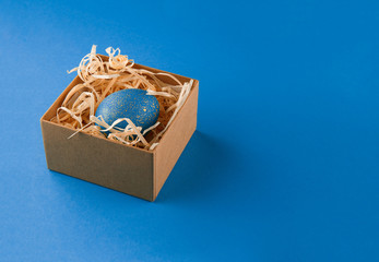 Easter egg painted blue with gold.