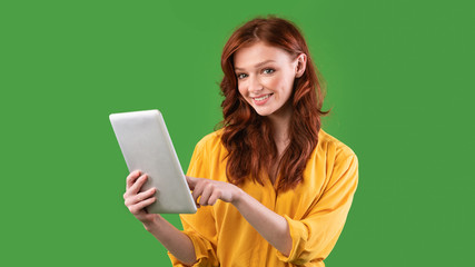 Student Girl Using Digital Tablet On Green Studio Background, Panorama