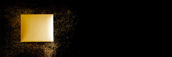 Banner Golden gift box on black background with confetti