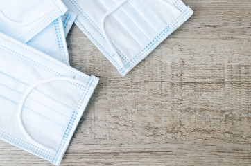 Medical mask, Medical protective mask on wooden texture for background. Disposable surgical face mask cover the mouth and nose. Healthcare and medical concept background.