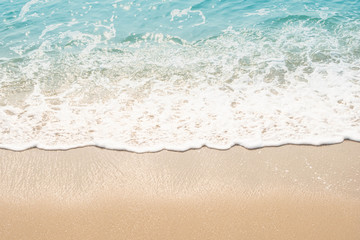 Fototapeta na wymiar wave of blue ocean on sandy beach. texture Background.