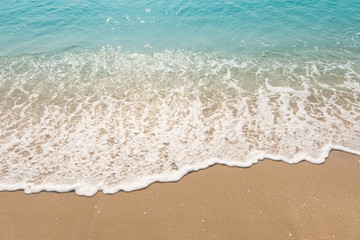 wave of blue ocean on sandy beach. texture Background.