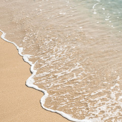 wave of blue ocean on sandy beach. texture Background.