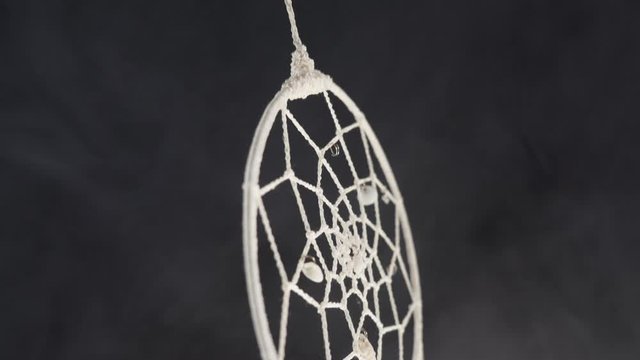 dreamcatcher with smoke concept of calm, pacification, care and protection 