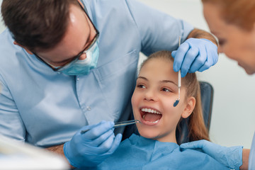 Portrait of female patient having treatment at dentist