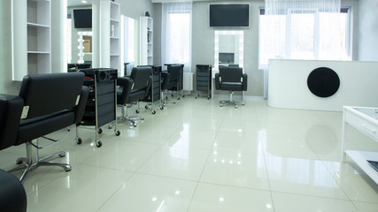 Armchairs for clients and places for hairdressers procedure