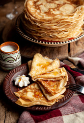 A stack of thin pancakes on a plate. Homemade pastries. Pancakes for breakfast. Appetizing food. Thin pancakes on a plate. Homemade crepes, tasty food. Staple of yeast pancakes.