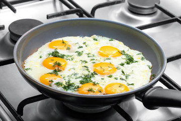Close-up photo of scrambled eggs in black frying pan