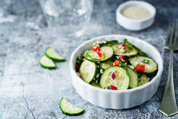 Cucumber spice salad with red onion, red pepper and sesame seeds