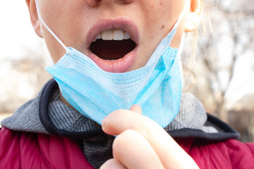 closeup of a young Ukrainian woman in a medical mask on her face during the 2020 pandemic outdoors