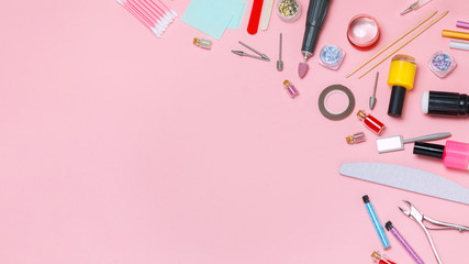 A set of cosmetic tools for manicure and pedicure on a white background. Gel polishes, nail files, manicure scissors, pusher and clippers top view. Composition for card with a place for text