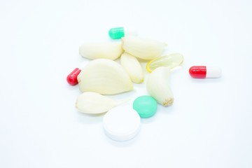 Obraz na płótnie Canvas Cloves garlic pill vitamins located on a white background