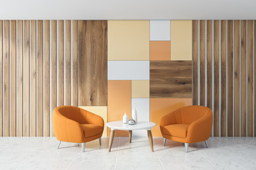 Wooden living room with orange armchairs