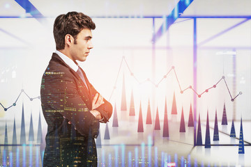 Confident businessman in office, financial graph