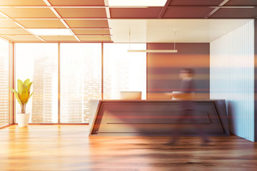 Man walks in white and gray office with reception