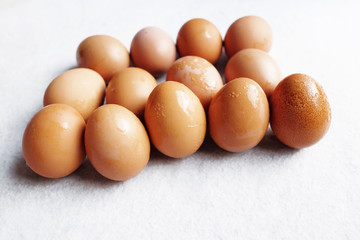 Fresh chicken eggs on white concrete floor background. The benefits of eating eggs are high protein.