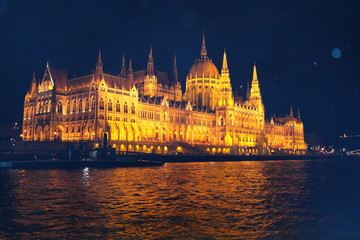 Fototapeta premium The building of the Hungarian Parliament in the fog, filmed at night from the Danube River