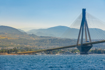 Motor Yacht and Ferry at Greek Bridge Over Gulf of Corinth
