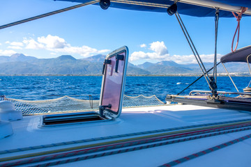 View From the Side of a Sailing Yacht on a Hilly Coast