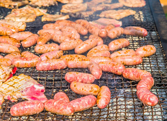 sausages and pork steaks on the large barbeque
