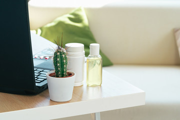 Working place table with small bottle of antibacterial sanitizer alcohol gel