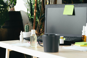 Medicine bottle on an office table with laptop close up