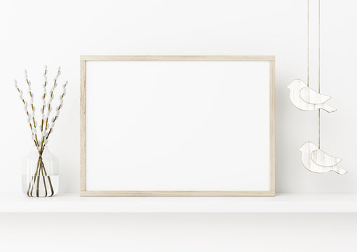 Horizontal poster frame mockup. Spring interior decoration with willow branches and hanging birds on empty white wall background. A4, A3 size format. 3D rendering, illustration.