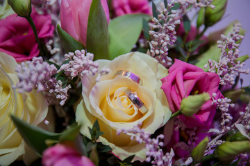 bouquet of flowers with wedding rings