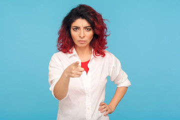 Choosing you! Portrait of hipster woman with fancy red hair in white shirt pointing finger to...