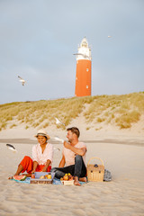 Picnic on the beach Texel Netherlands, couple having picnic on the beach of Texel with white sand...