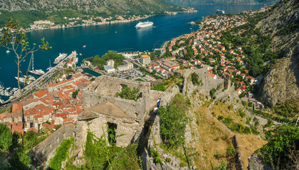 A panoramic view of the Bay of Kotor, cruise port, mountains and the medieval walled old town from the ruins of the Castle of San Giovanni
