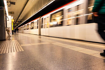 Blurry image of a subway station. Train in motion blur