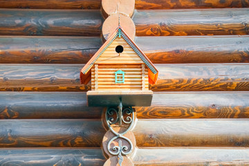 birdhouse on the wall of timber