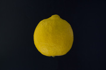 yellow lemon on a black background