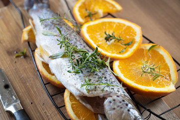 Trout is prepared for grilling with herbs and spices