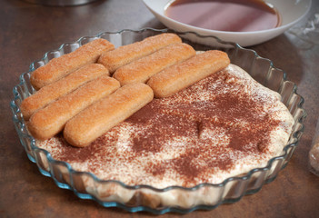 Process of making house made Tiramisu cake. Italian desert with Philadelphia cheese and eggs.