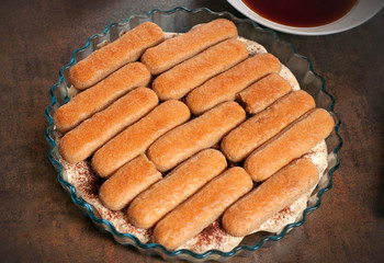 Process of making house made Tiramisu cake. Italian desert with Philadelphia cheese and eggs.