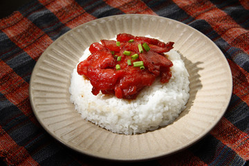 Freshly cooked Tocino or cured pork meat served with fried rice and egg with vegetables