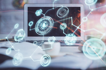 Computer on desktop with social network hologram. Multi exposure. Concept of international people connections.