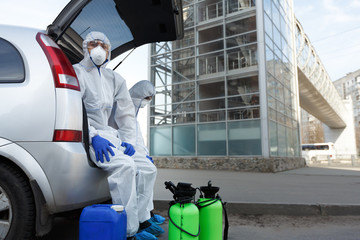 Virologists in protective suits planning to do disinfection